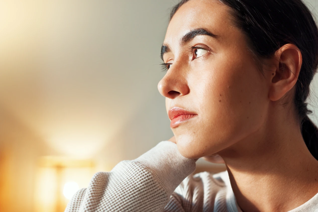 A woman in quiet reflection, part of the eating disorder recovery journey