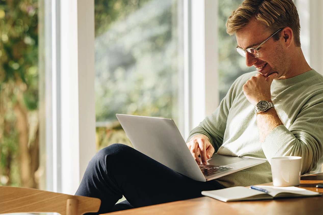 A young man in a telehealth therapy session from home